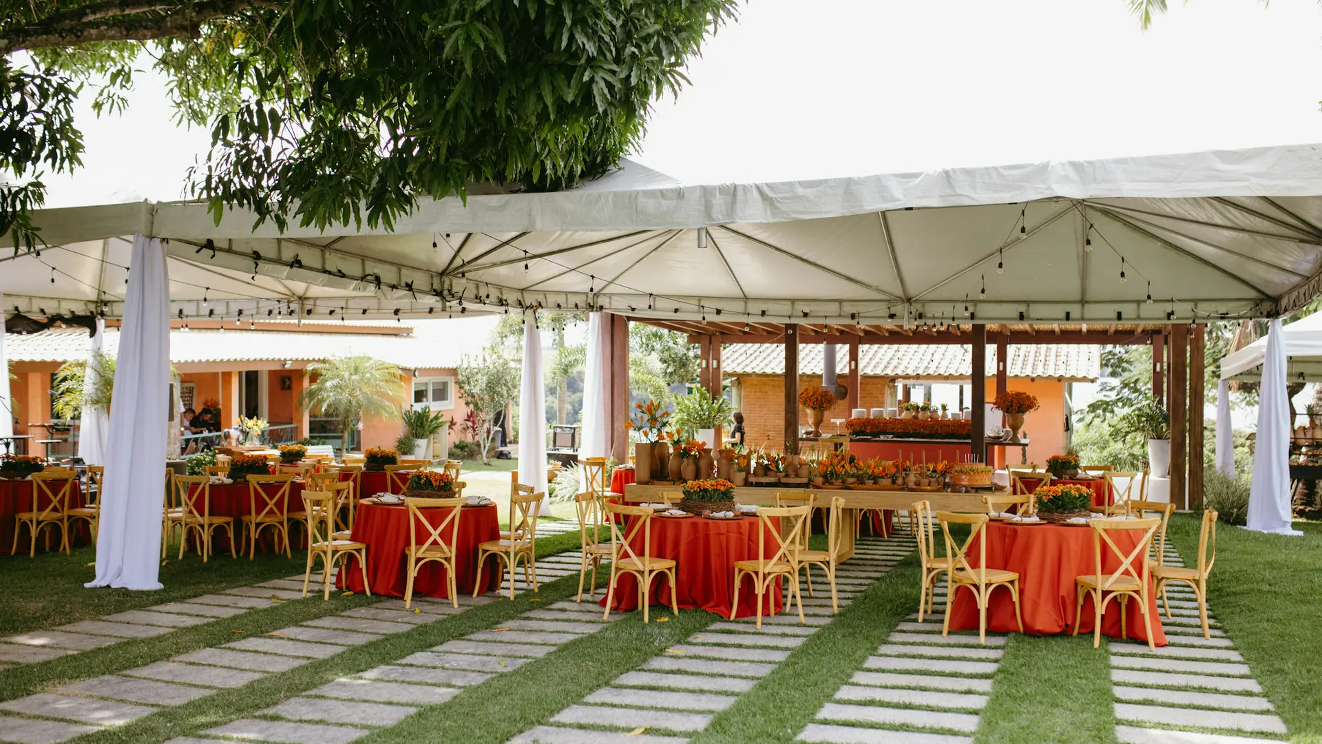 Finished outdoor event tent with guest tables and chairs