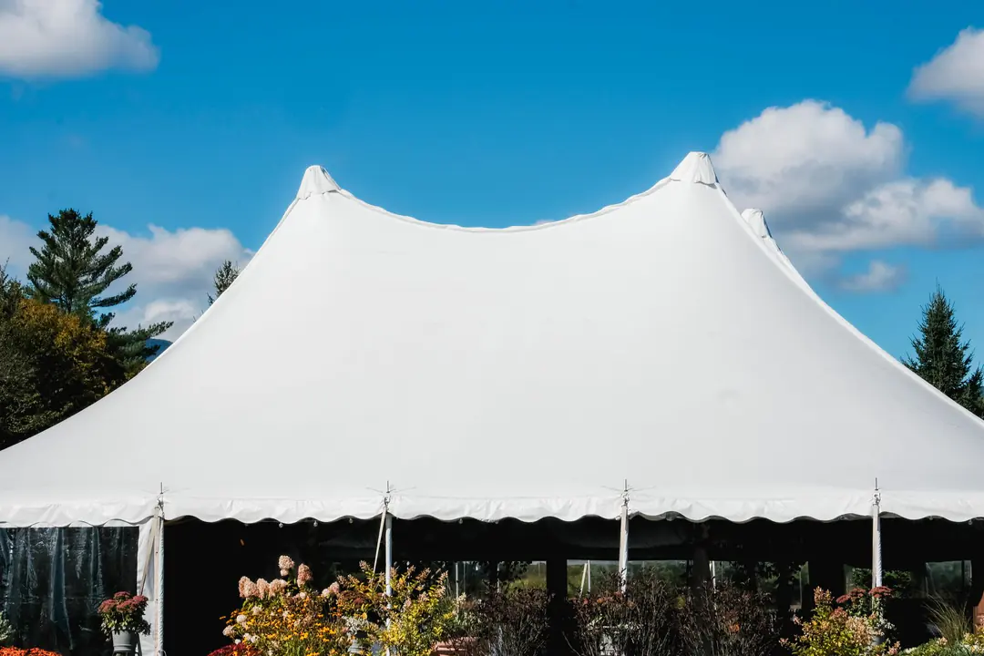 White event tent installed for an outdoor celebration